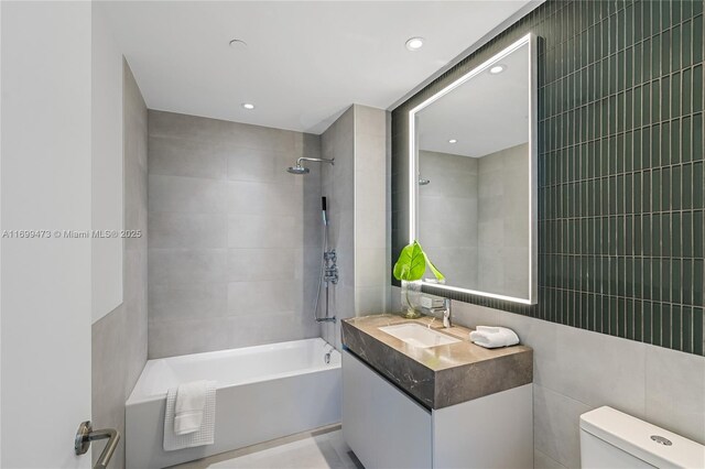 500 Alton Unit 2405/06, Miami Beach, FL 33139 - bathroom featuring recessed lighting, tile walls, toilet, shower / bathtub combination, and vanity