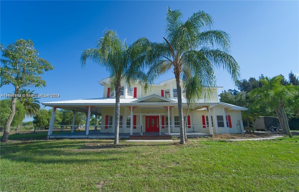 country-style home with covered porch and a front yard