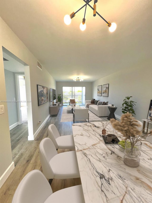 dining area featuring a chandelier and wood-type flooring