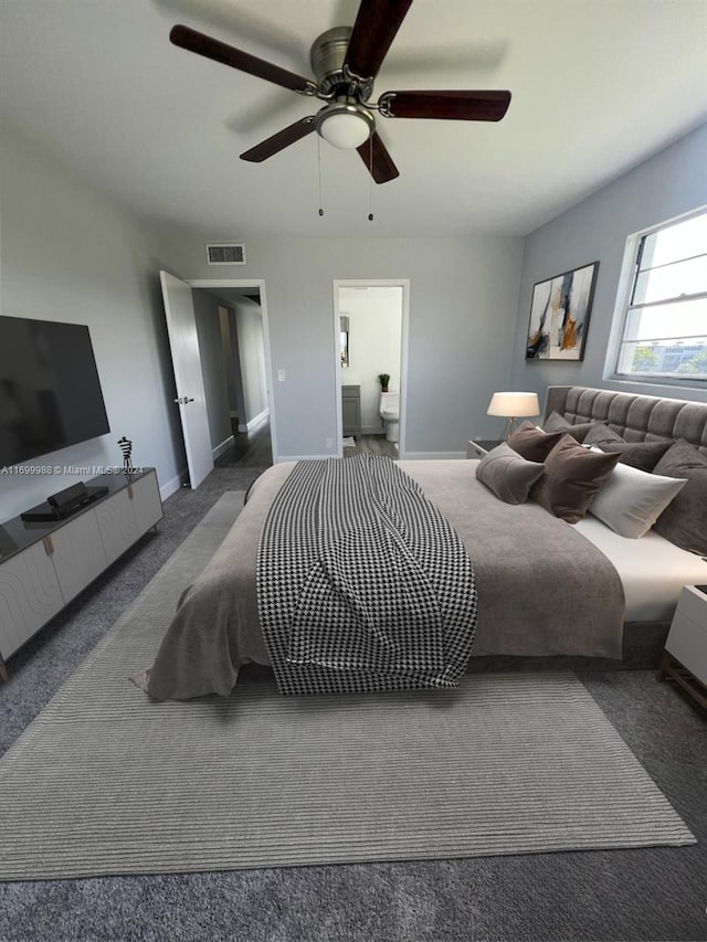 carpeted bedroom featuring ceiling fan and ensuite bath