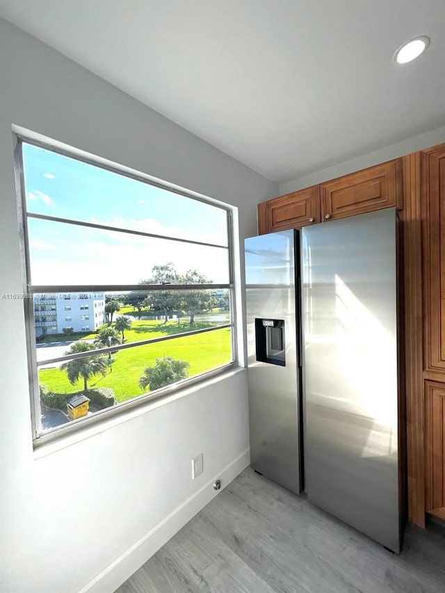 kitchen featuring light hardwood / wood-style floors and stainless steel refrigerator with ice dispenser