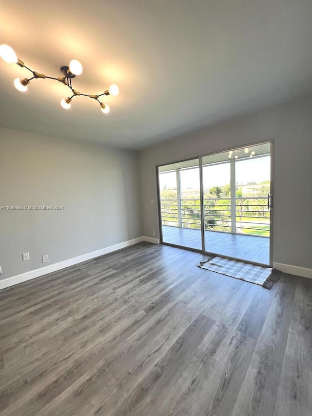 spare room featuring wood-type flooring