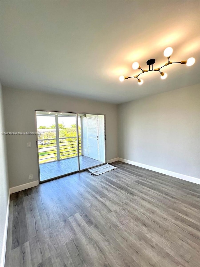 spare room with hardwood / wood-style floors