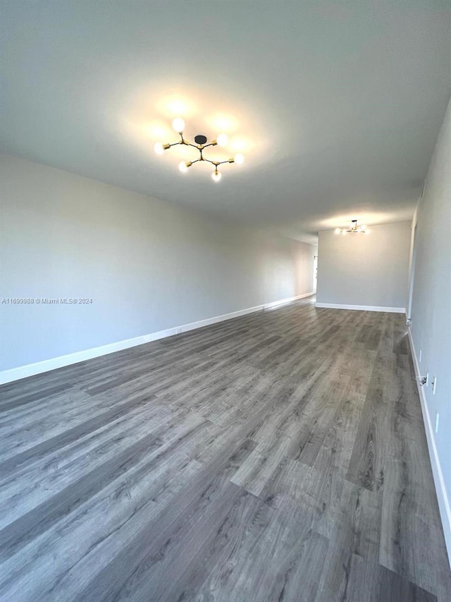 unfurnished room with wood-type flooring