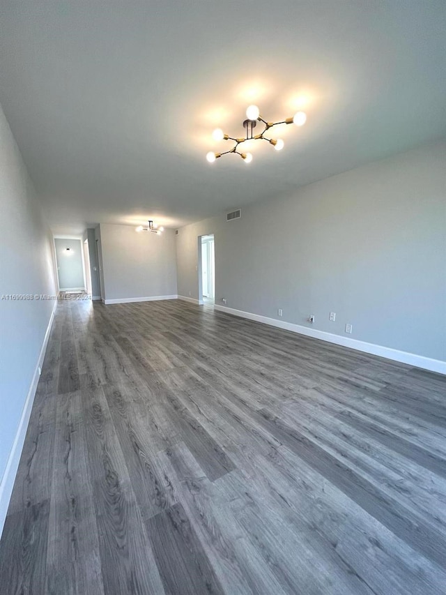 unfurnished living room with dark hardwood / wood-style flooring