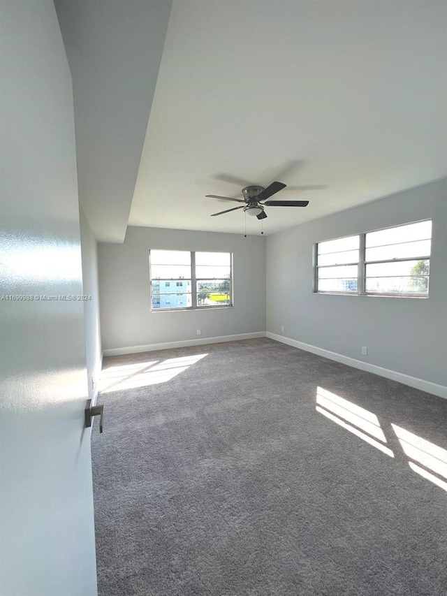 spare room with carpet and ceiling fan