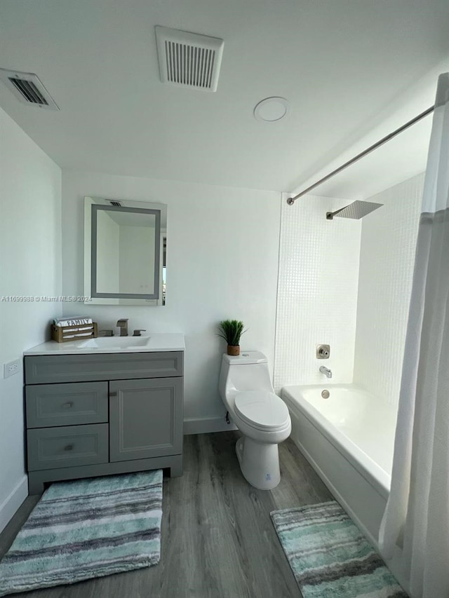 full bathroom with hardwood / wood-style floors, vanity, bathtub / shower combination, and toilet