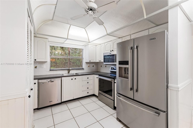 kitchen with backsplash, stainless steel appliances, ceiling fan, sink, and white cabinetry