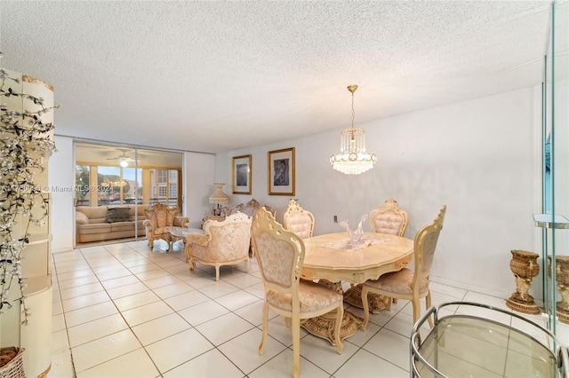 dining area with light tile patterned floors, a textured ceiling, and a chandelier