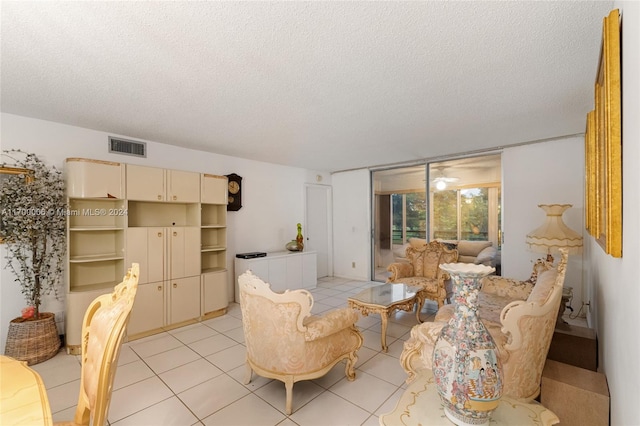 living room featuring light tile patterned flooring and a textured ceiling