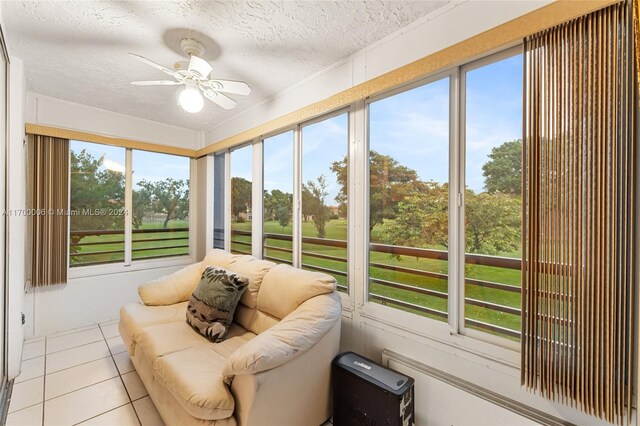 sunroom / solarium featuring ceiling fan and a healthy amount of sunlight