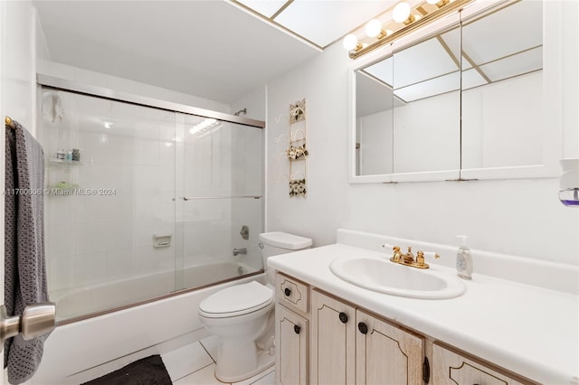 full bathroom featuring tile patterned floors, shower / bath combination with glass door, vanity, and toilet