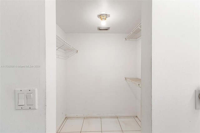 spacious closet featuring light tile patterned flooring