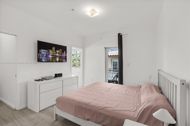 bedroom featuring light hardwood / wood-style floors and radiator heating unit