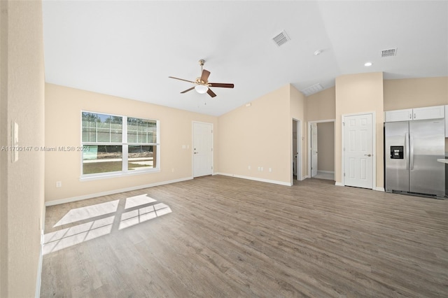 unfurnished living room with light hardwood / wood-style flooring, vaulted ceiling, and ceiling fan