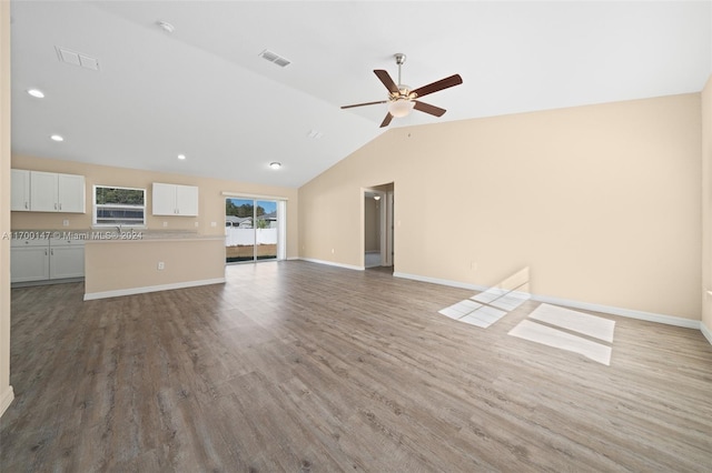 unfurnished living room with ceiling fan, light hardwood / wood-style flooring, and vaulted ceiling