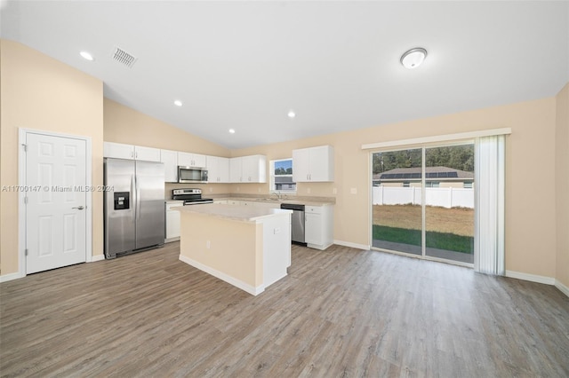 kitchen with sink, a center island, stainless steel appliances, light hardwood / wood-style flooring, and white cabinets