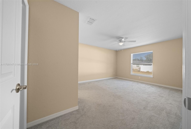 carpeted empty room with ceiling fan