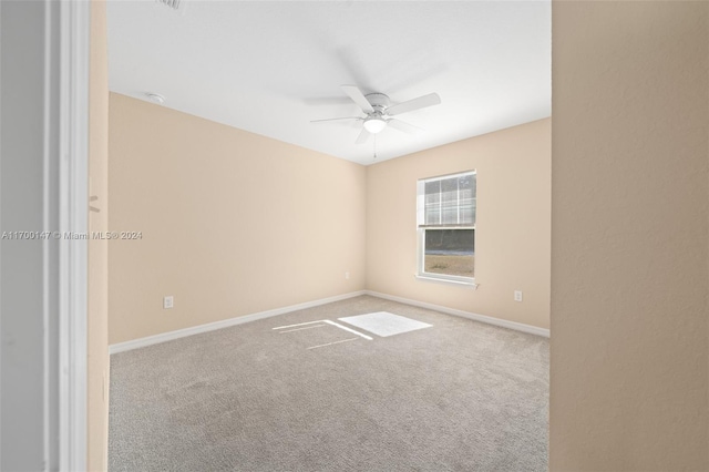 spare room with carpet flooring and ceiling fan