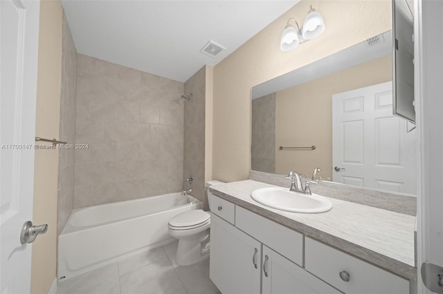 full bathroom featuring tile patterned floors, vanity, tiled shower / bath combo, and toilet