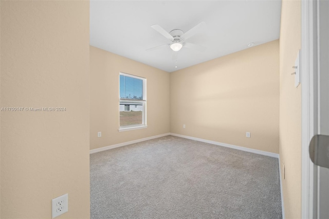 spare room featuring light carpet and ceiling fan