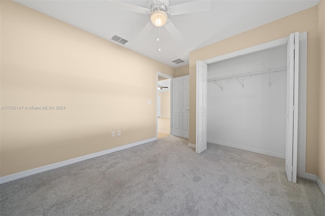 unfurnished bedroom with ceiling fan, light colored carpet, and a closet