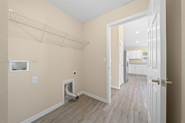 washroom with electric dryer hookup, hookup for a washing machine, and light hardwood / wood-style floors