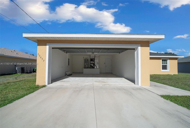 garage with a yard and central AC