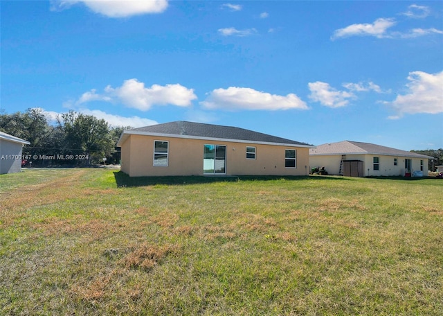 back of property with a lawn