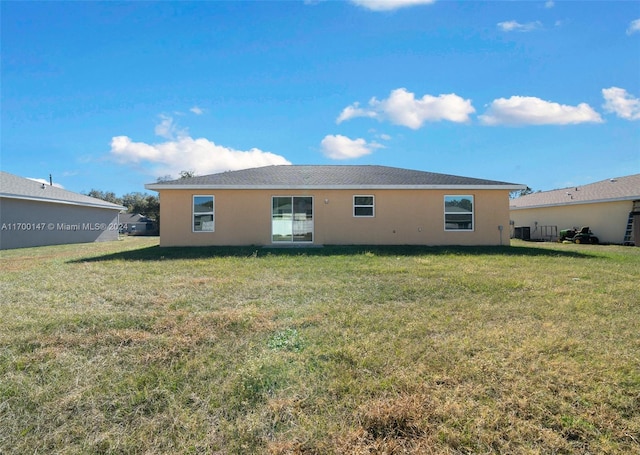 rear view of property with a yard