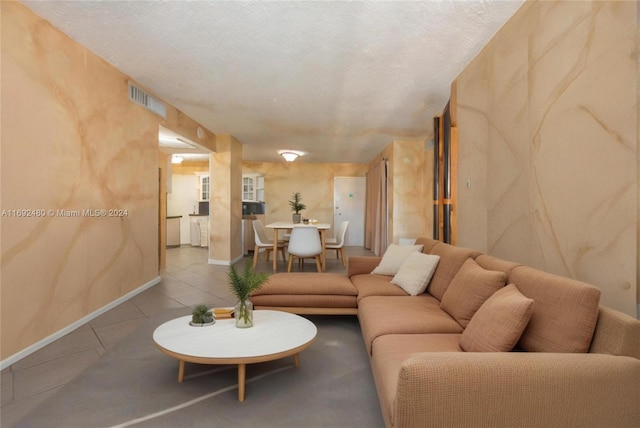 living room with light tile patterned floors and a textured ceiling