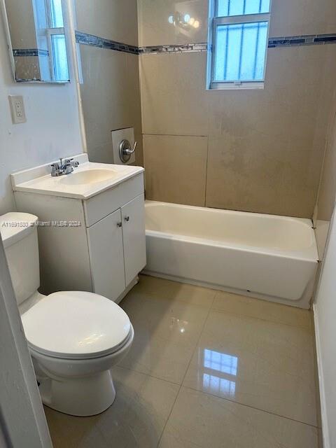 full bathroom featuring tile patterned floors, vanity, toilet, and bathing tub / shower combination