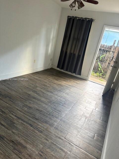 empty room with hardwood / wood-style floors and ceiling fan