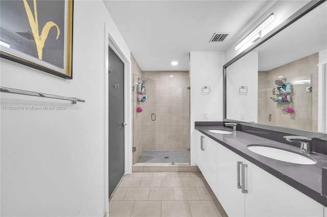 bathroom featuring tile patterned flooring, vanity, and walk in shower