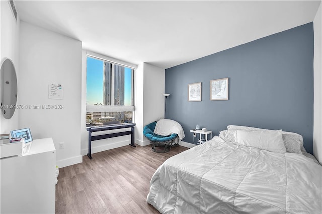 bedroom with wood-type flooring