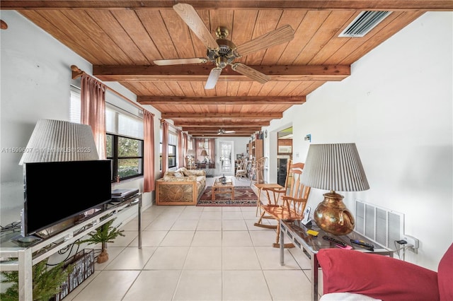 living area with light tile patterned flooring, visible vents, and plenty of natural light