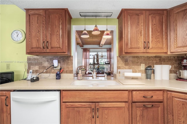 kitchen featuring backsplash, dishwasher, light countertops, and a sink