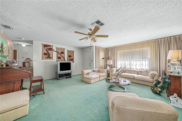 carpeted living area with visible vents, a textured ceiling, and a ceiling fan