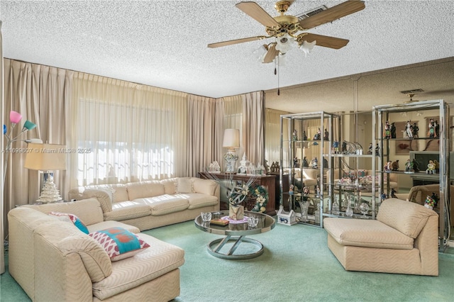 living room featuring a ceiling fan, a textured ceiling, and carpet flooring