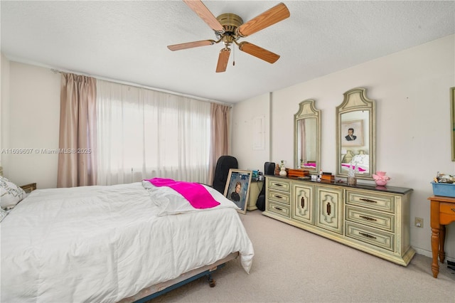 bedroom with light colored carpet, a textured ceiling, and ceiling fan