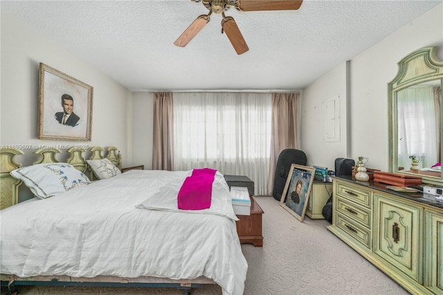 carpeted bedroom with a textured ceiling and ceiling fan