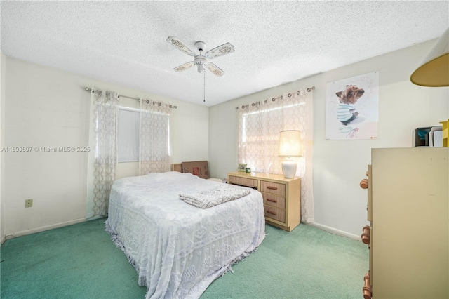 bedroom featuring ceiling fan, light colored carpet, baseboards, and a textured ceiling