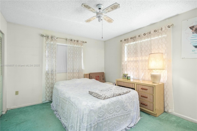 bedroom featuring baseboards, light carpet, and a textured ceiling