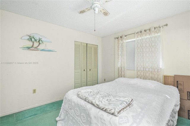 carpeted bedroom featuring a closet, baseboards, a textured ceiling, and a ceiling fan