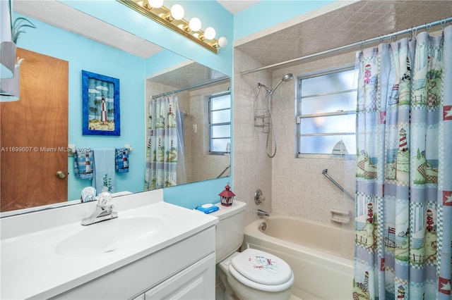 full bath with vanity, shower / tub combo, and toilet