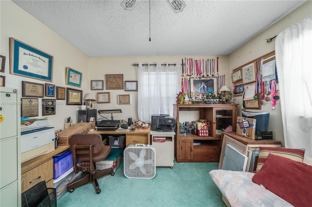 home office with a textured ceiling and carpet flooring