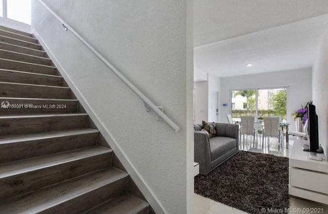 staircase featuring tile patterned floors