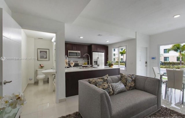 living room with light tile patterned floors and sink