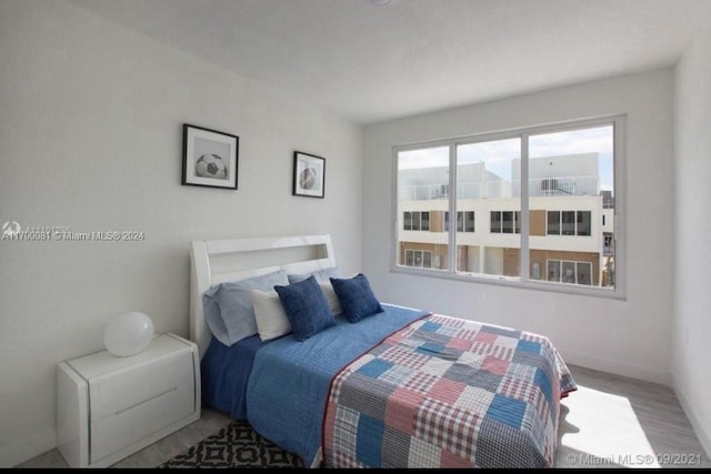 bedroom with hardwood / wood-style floors