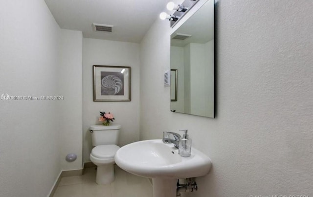 bathroom with tile patterned floors, sink, and toilet